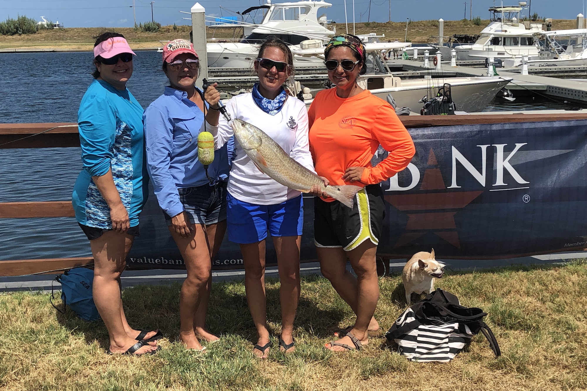 Women posing with a fish they caught fishing